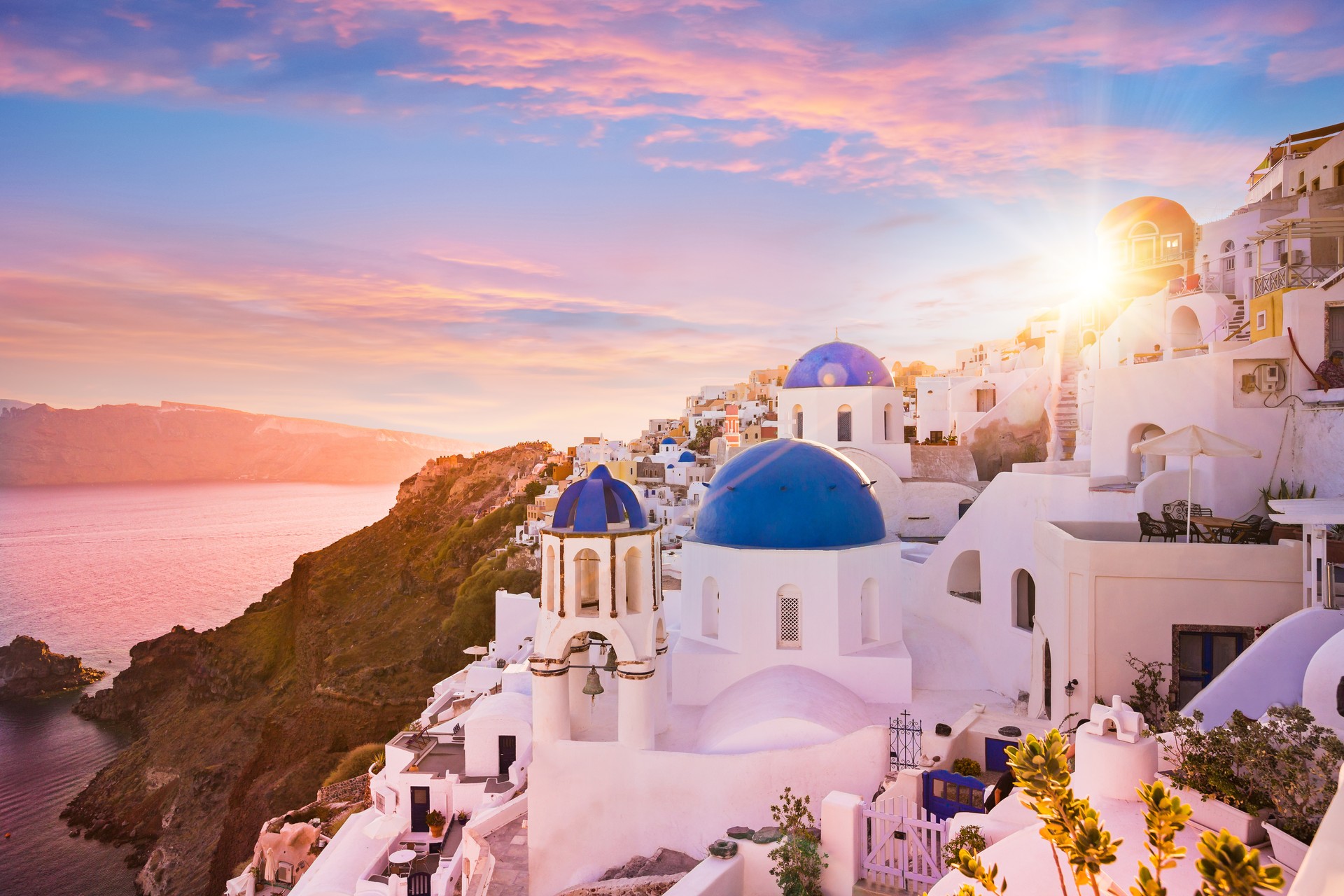 Sunset view of the blue dome churches of Santorini, Greece